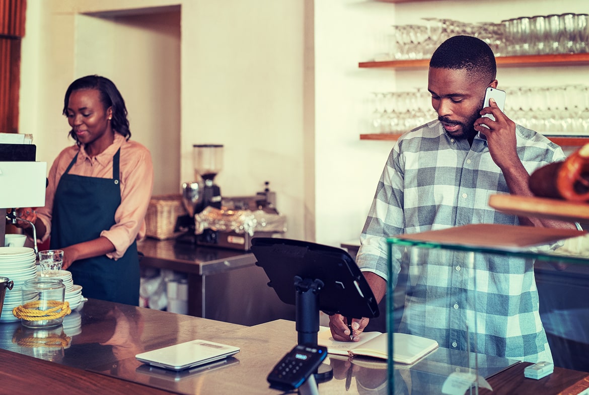 Man and women working at a cafe